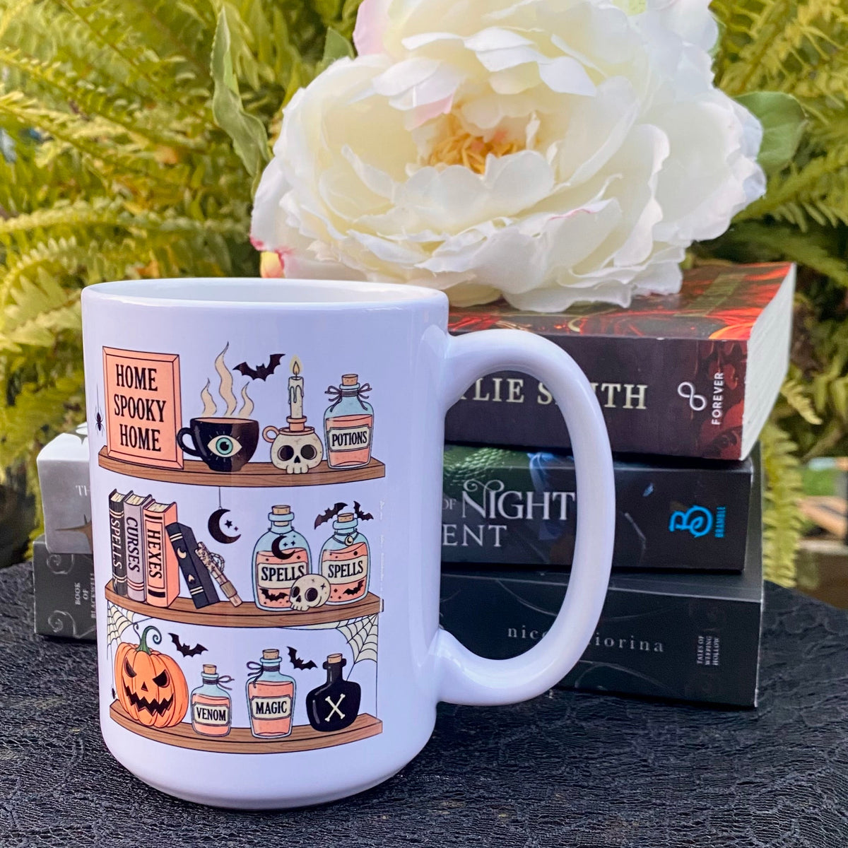 StoryBoundBox Spooky Book Shelf Mug 15oz featuring a haunted bookshelf design, ceramic drinkware for Halloween or spooky themes.