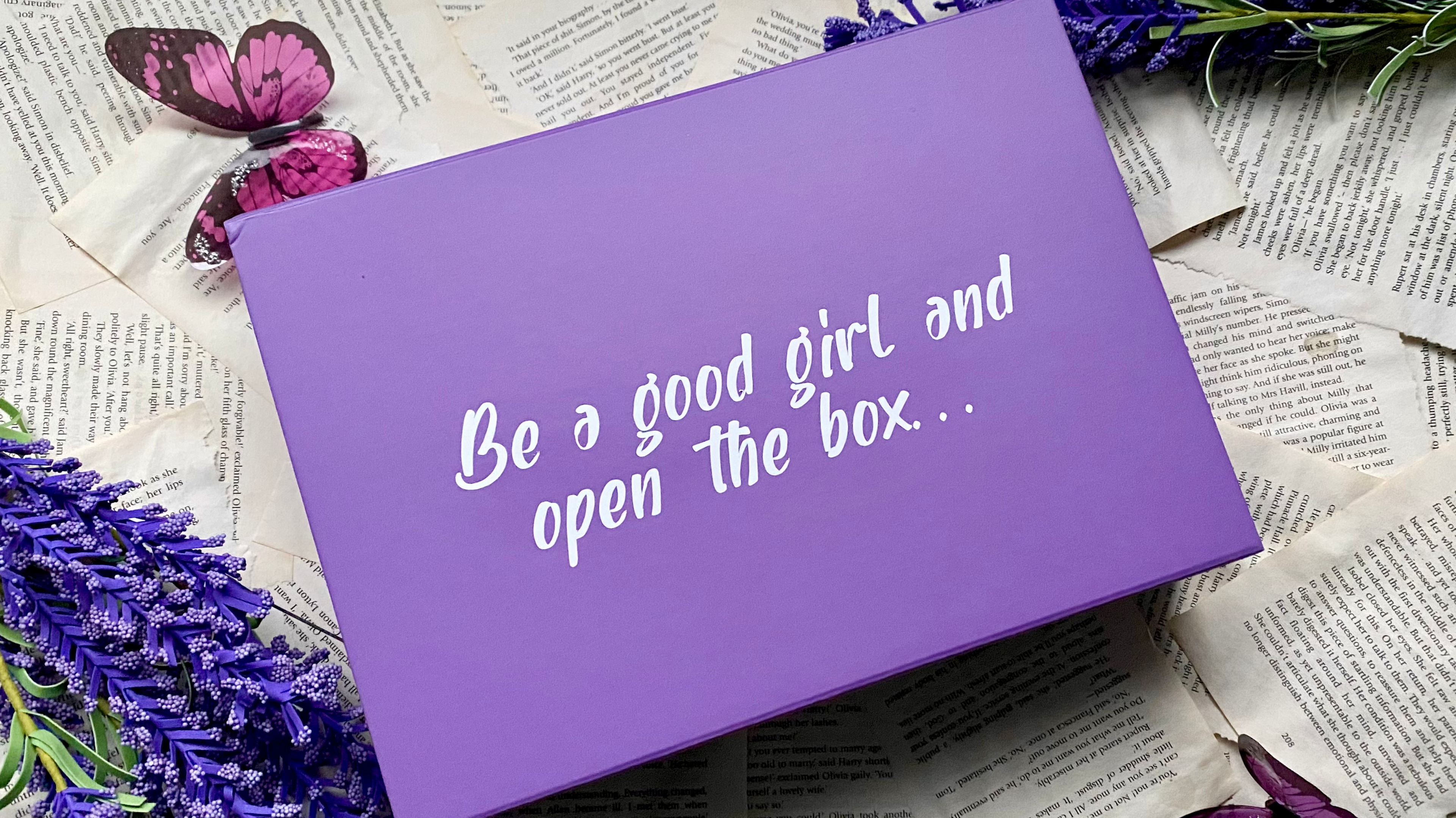 Purple monthly book subscription box with the phrase ‘Be a Good Girl and Open the Box’ printed on the lid – perfect for book lovers and surprise readers.