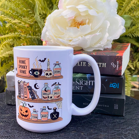 StoryBoundBox Spooky Book Shelf Mug 15oz featuring a haunted bookshelf design, ceramic drinkware for Halloween or spooky themes.