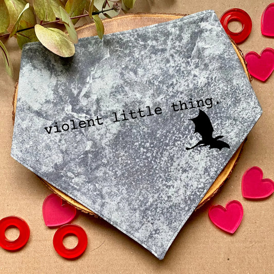 Clip-on dog bandana inspired by fantasy, romantic, and romance books – easy to wear and perfect for book-loving pet owners who want to add a touch of literary charm to their dog’s style.